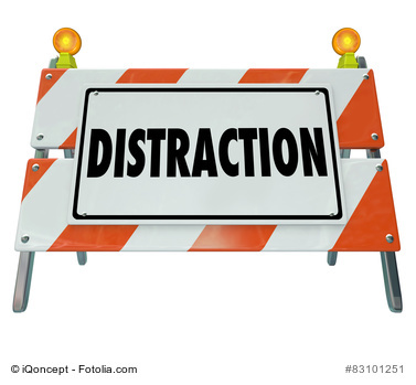 Distraction word on a road construction barrier or sign to illustrate dangerous inattentive driving or hazardous situation