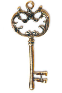 ornate vintage metal key on a white background